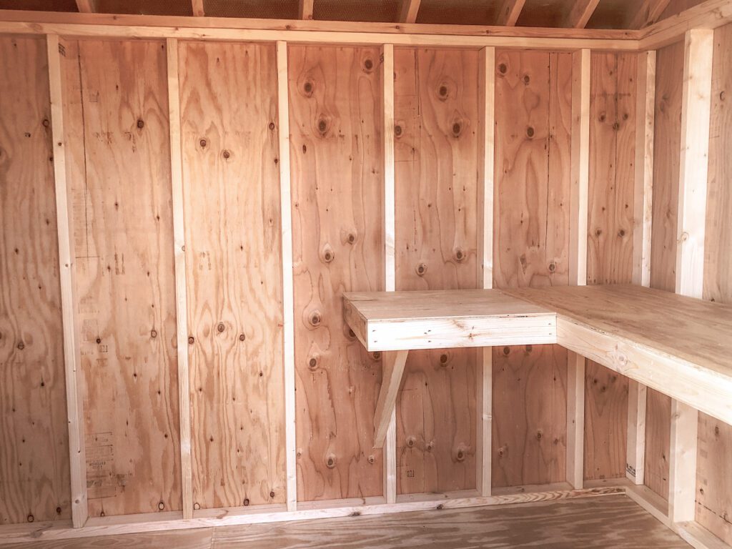 A shed's interior with a wooden workbench.