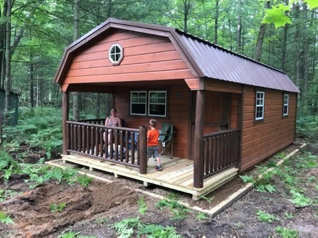 family on cabin porch