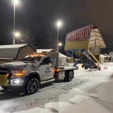 A horse shelter being loaded on a delivery truck.